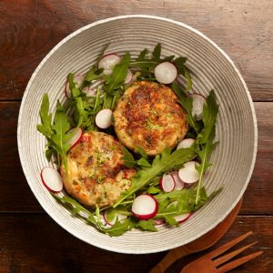 Fishcakes served with rocket leaves and radishes